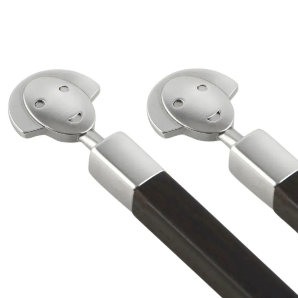 Conjunto de dos palillos de ébano con soporte de inox Alessandro Mendini Alessi